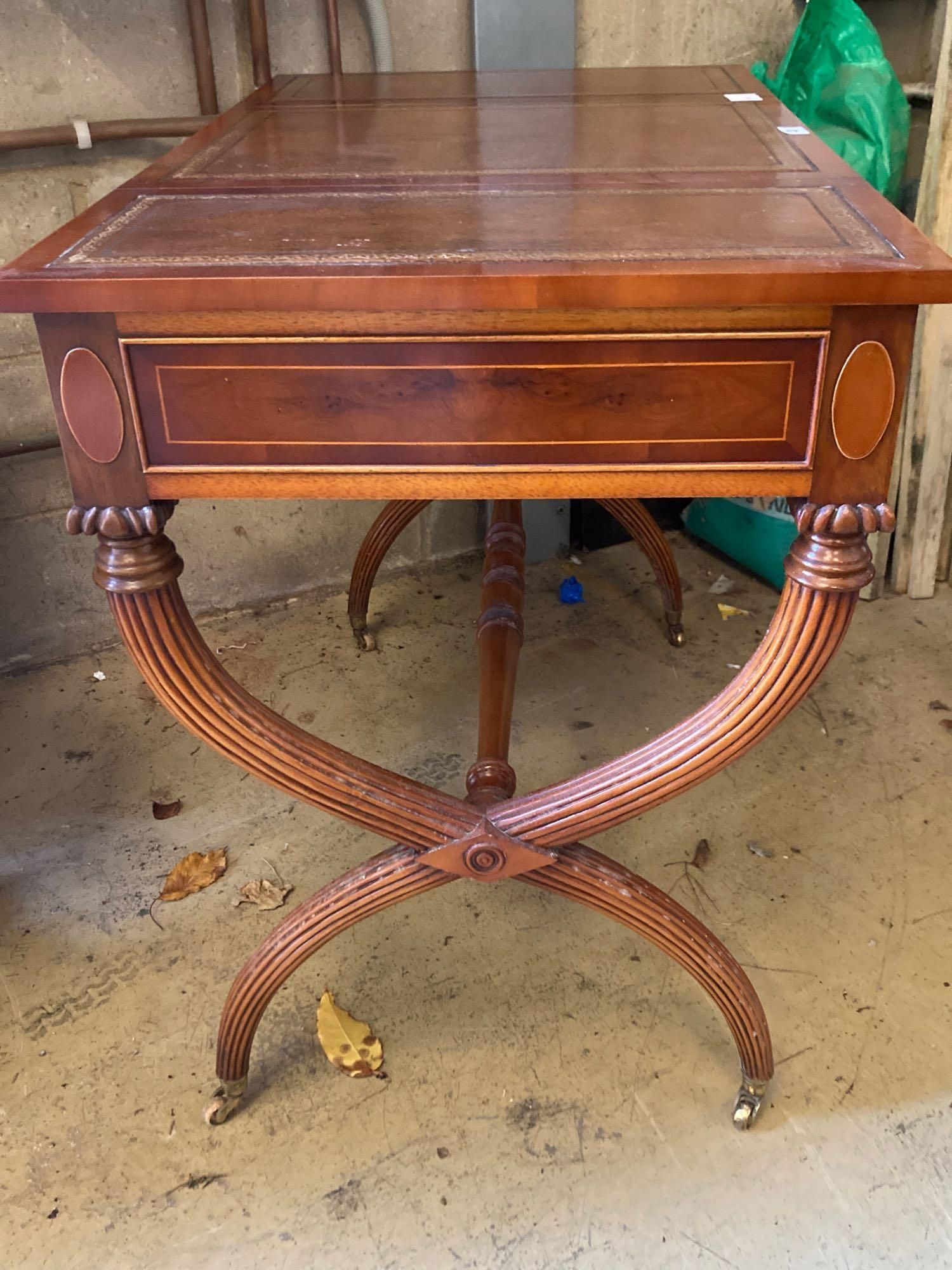 A modern yew wood and mahogany writing table, with sliding backgammon and chessboard top, width 92cm